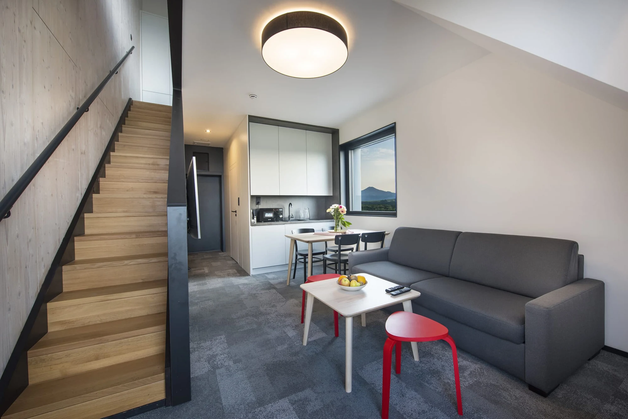 Svetlý interiér apartmánu v Demänová Rezorte so schodiskom a obývacou časťou